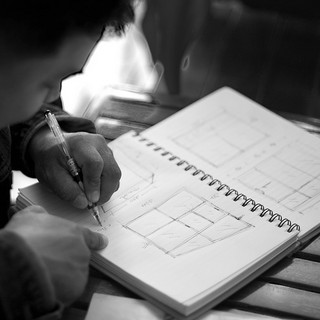 A man sketching notes in a sketchbook